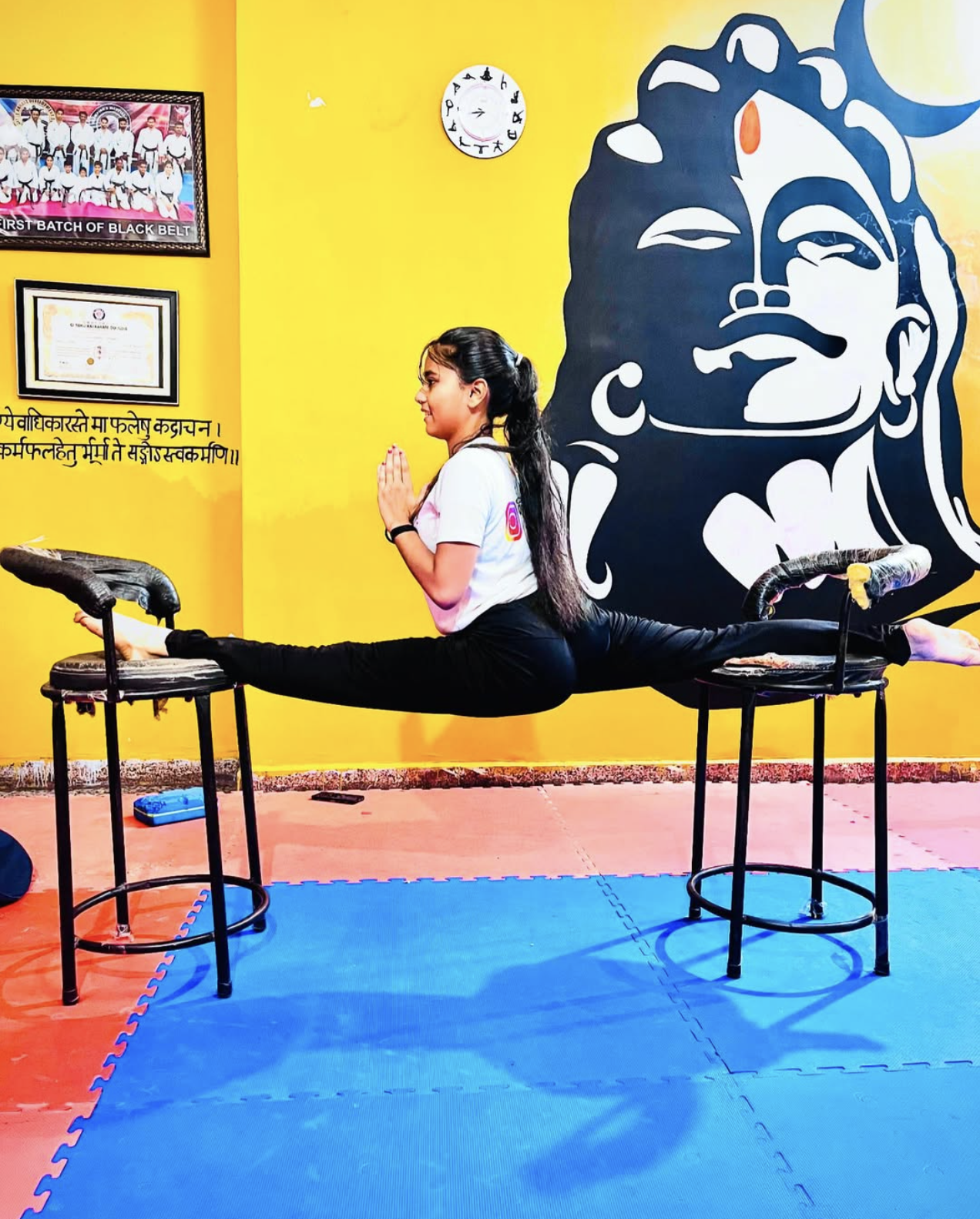 Student in elevated splits pose